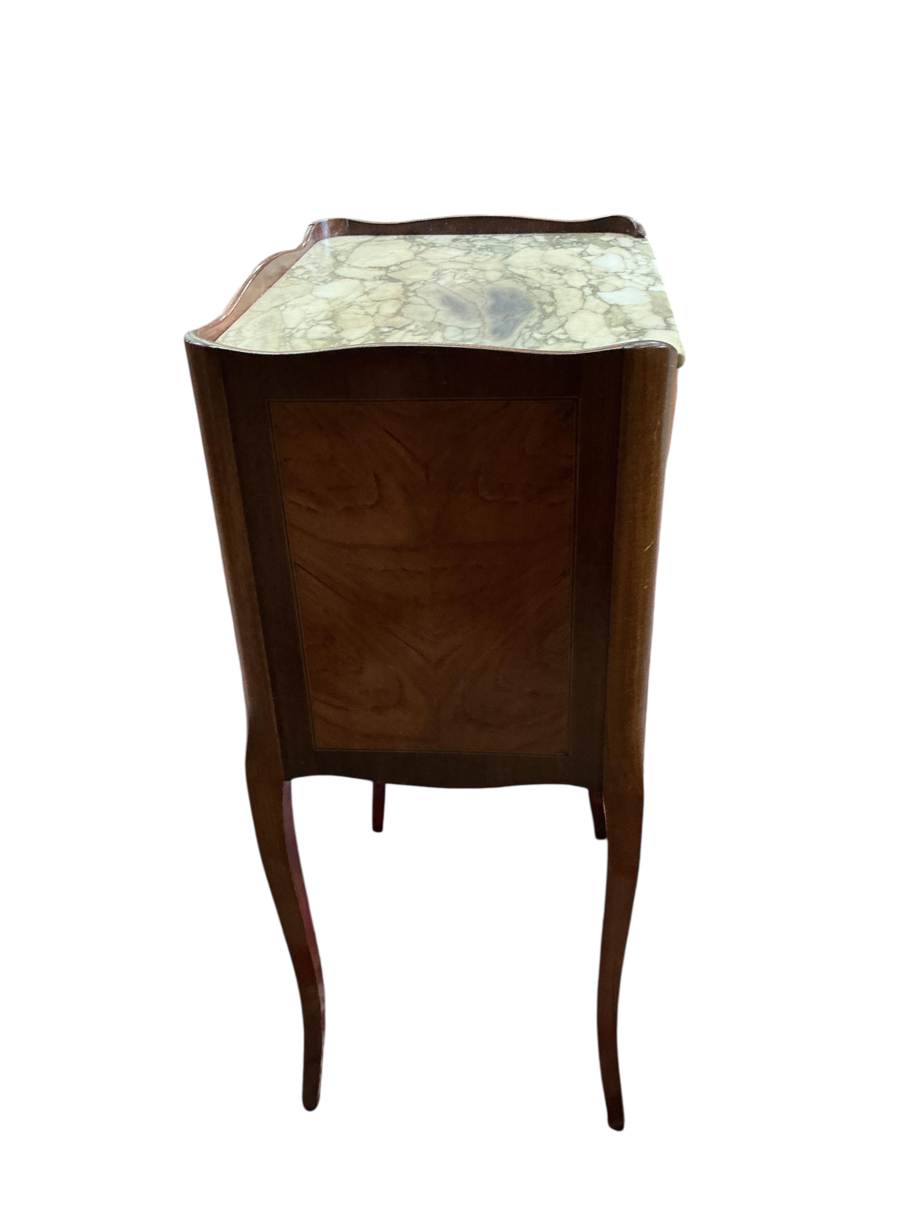 A pair of French marble topped kingswood bedside cabinets with faux book spine doors, width 39cm, depth 30cm, height 74cm